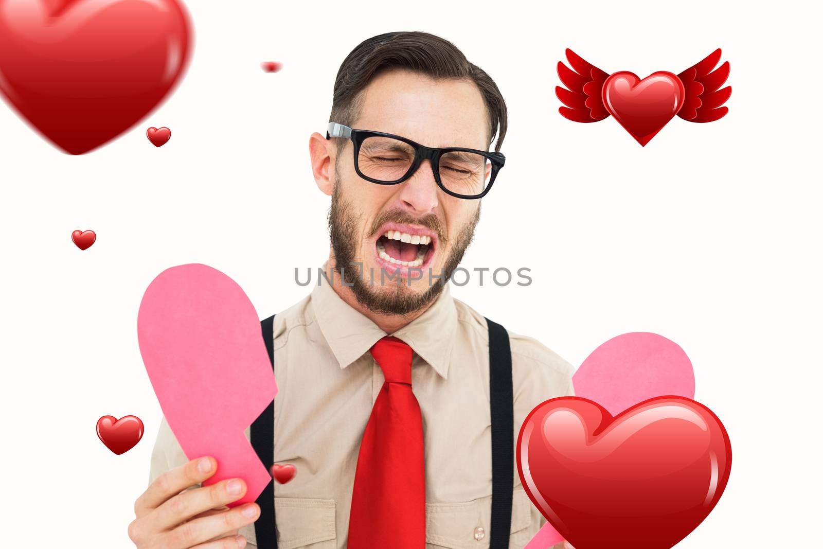 Geeky hipster crying and holding broken heart card against hearts