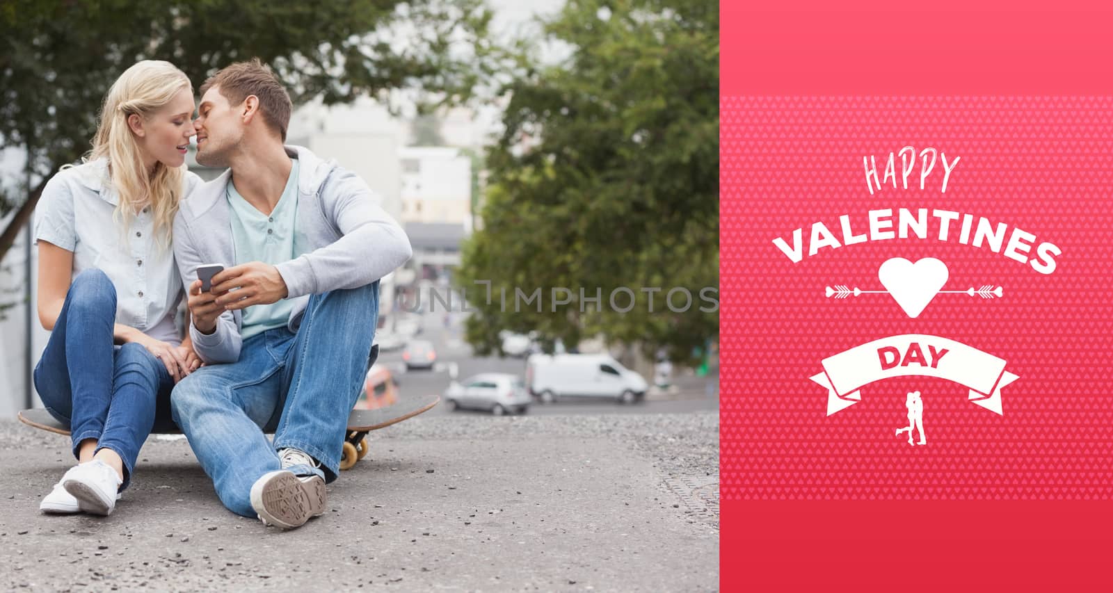 Cute young couple sitting on skateboard kissing against happy valentines day