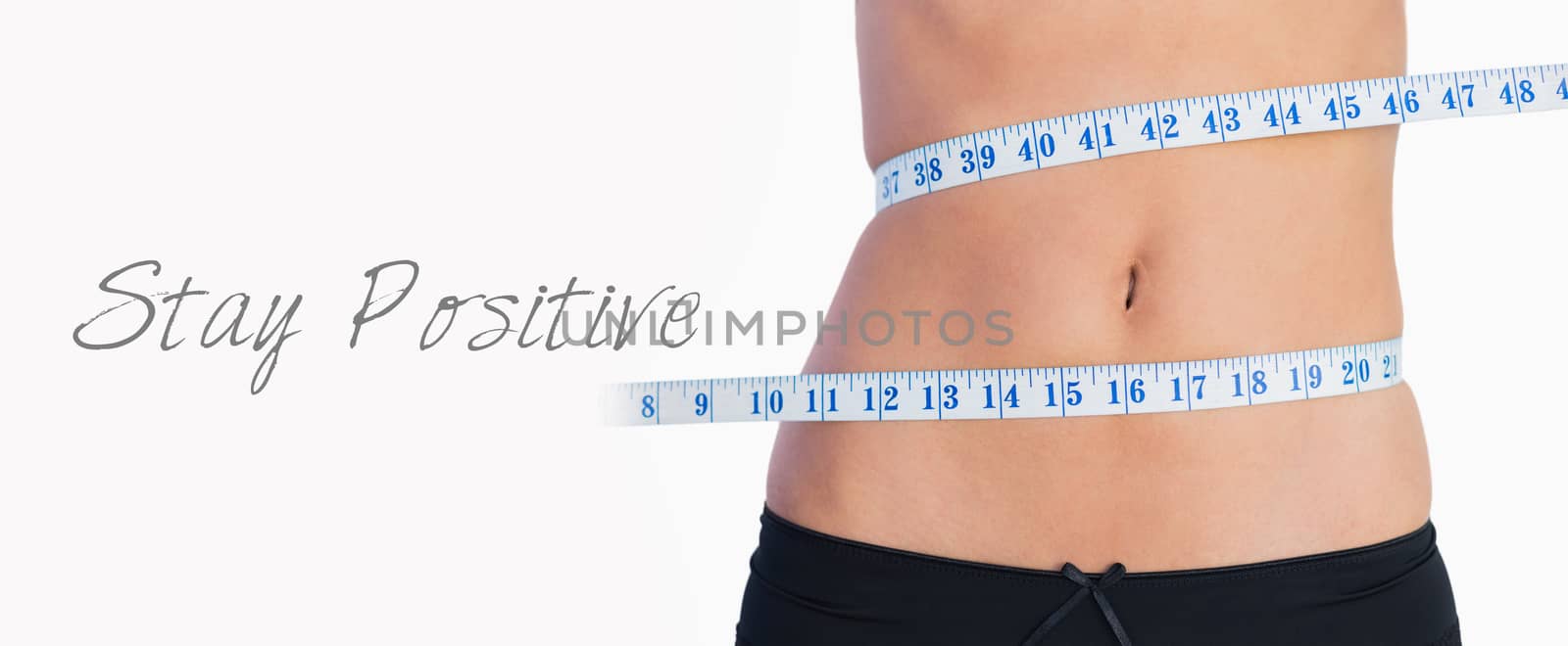 Fit belly surrounded by measuring tape by Wavebreakmedia