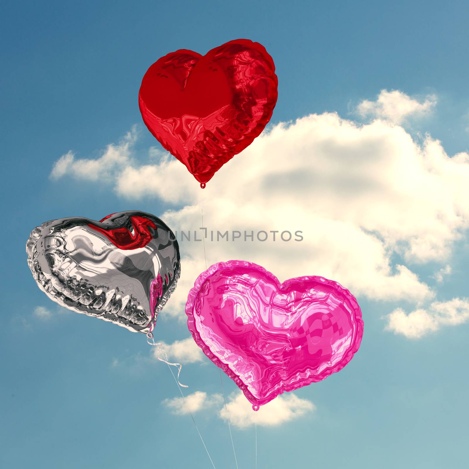 Love heart balloons against cloudy sky