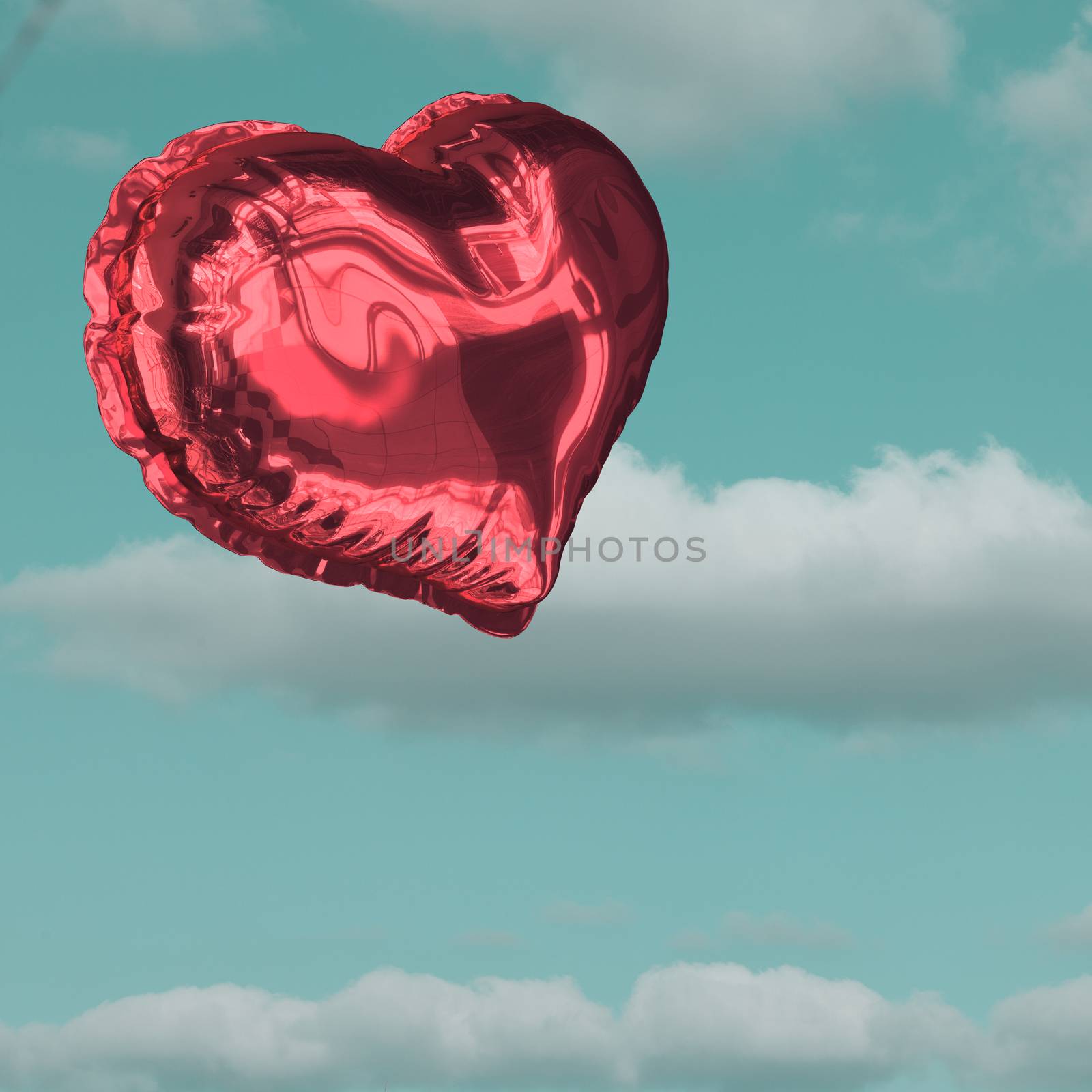 Red heart balloon against sky 