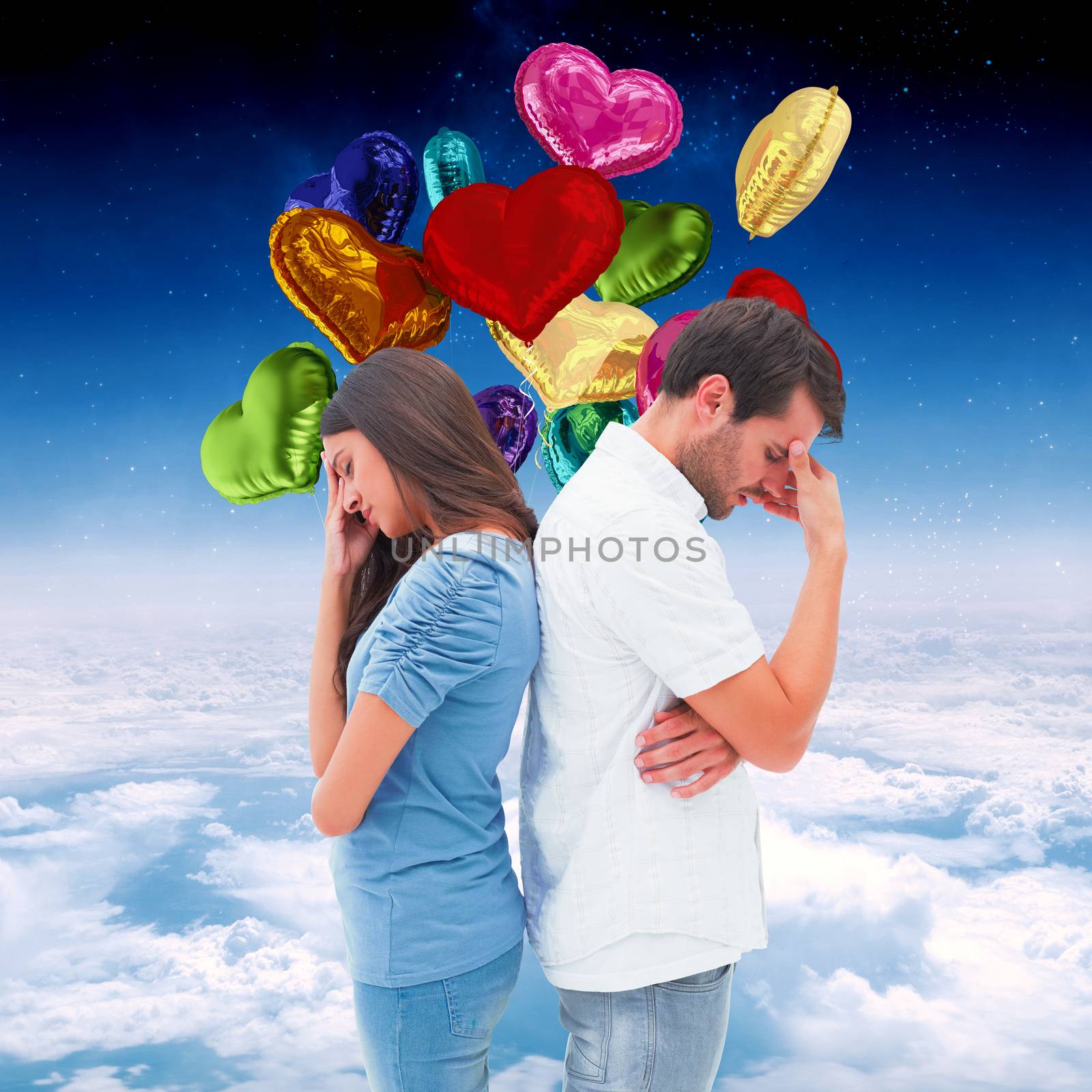 Upset couple not talking to each other after fight against white clouds under blue sky