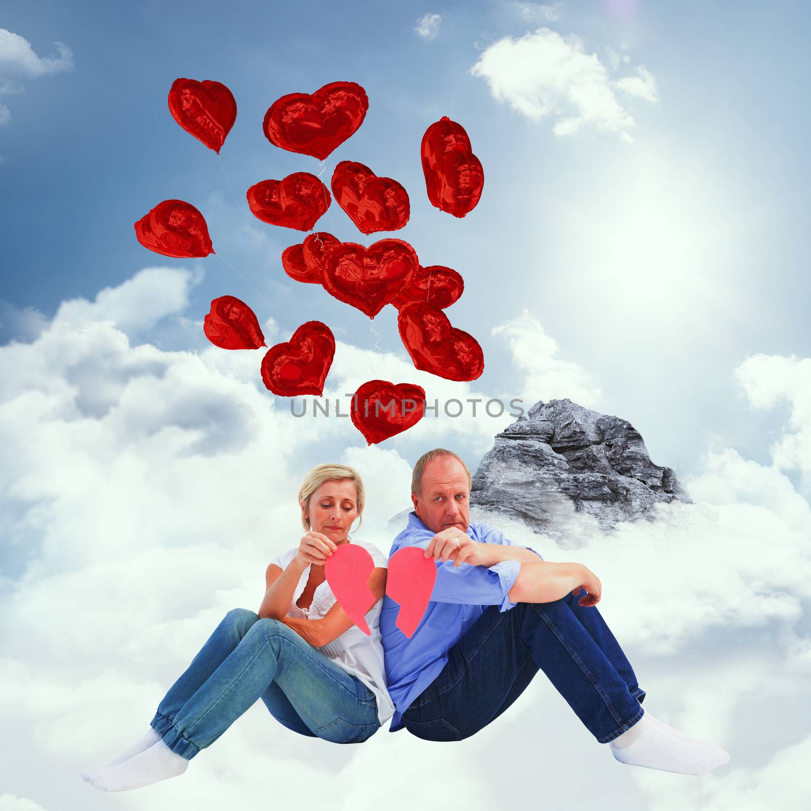 Composite image of sad mature couple holding a broken heart by Wavebreakmedia