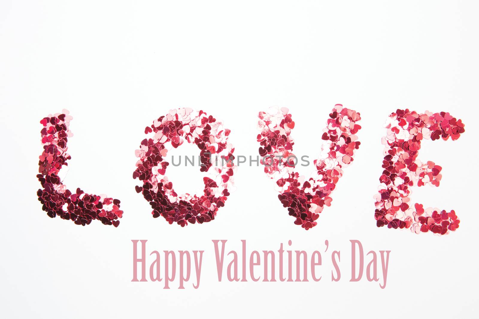 Composite image of pink confetti spelling out love by Wavebreakmedia