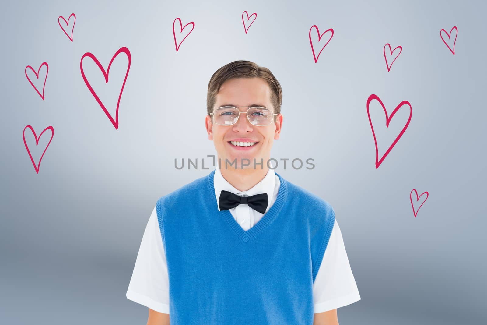 Geeky hipster smiling at camera against grey vignette