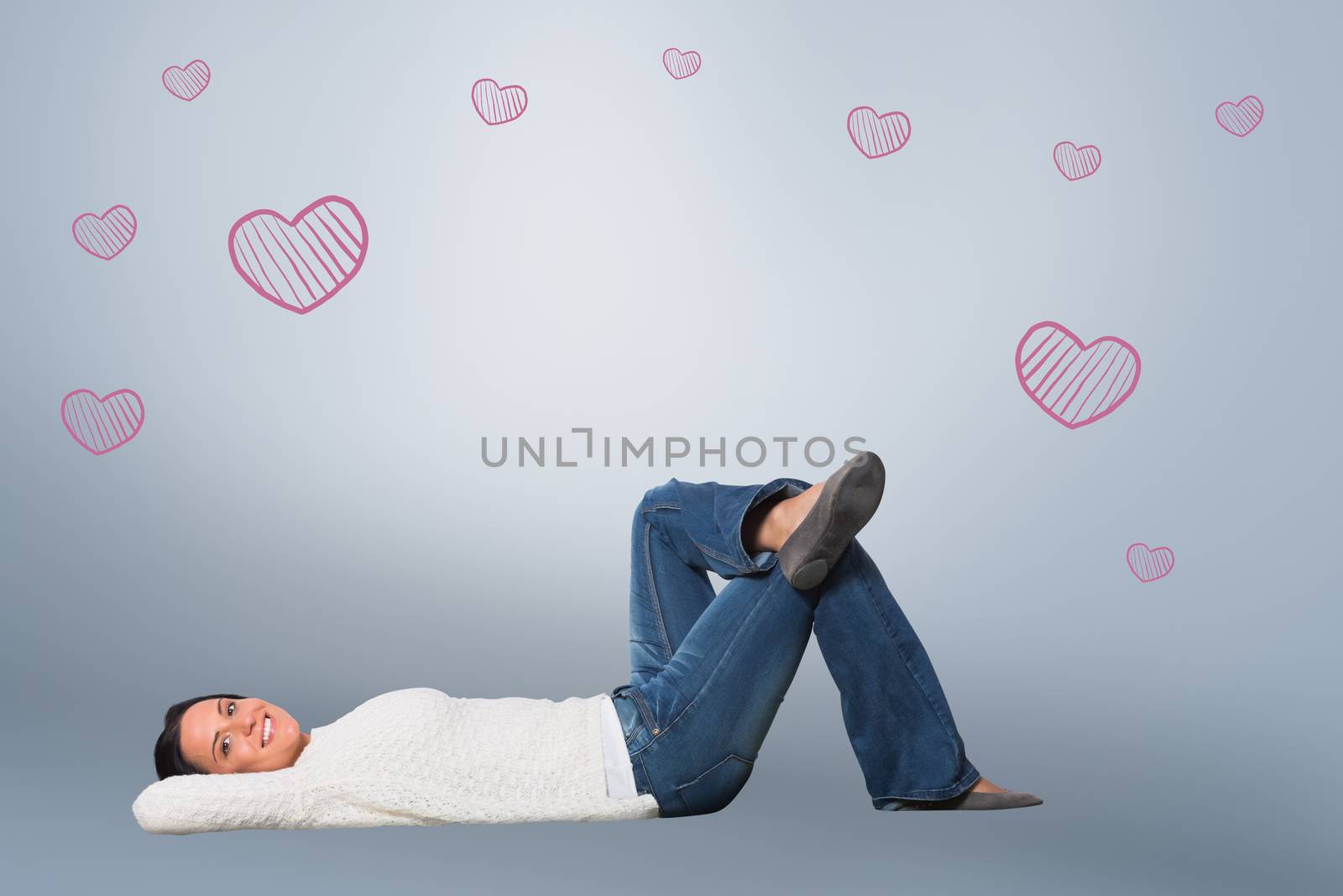 Composite image of young woman lying on floor smiling by Wavebreakmedia