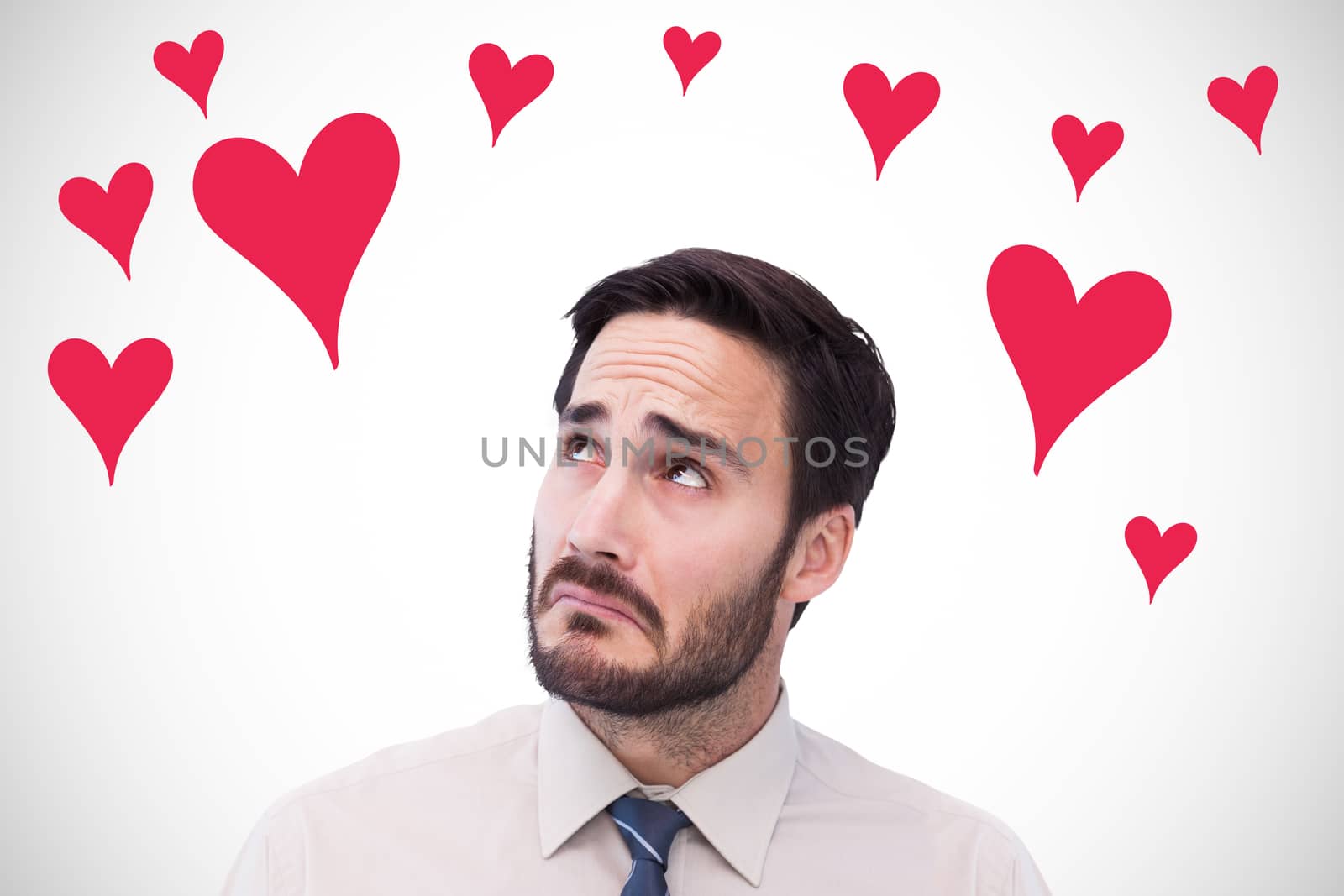 Portrait of a nervous businessman looking up against white background with vignette