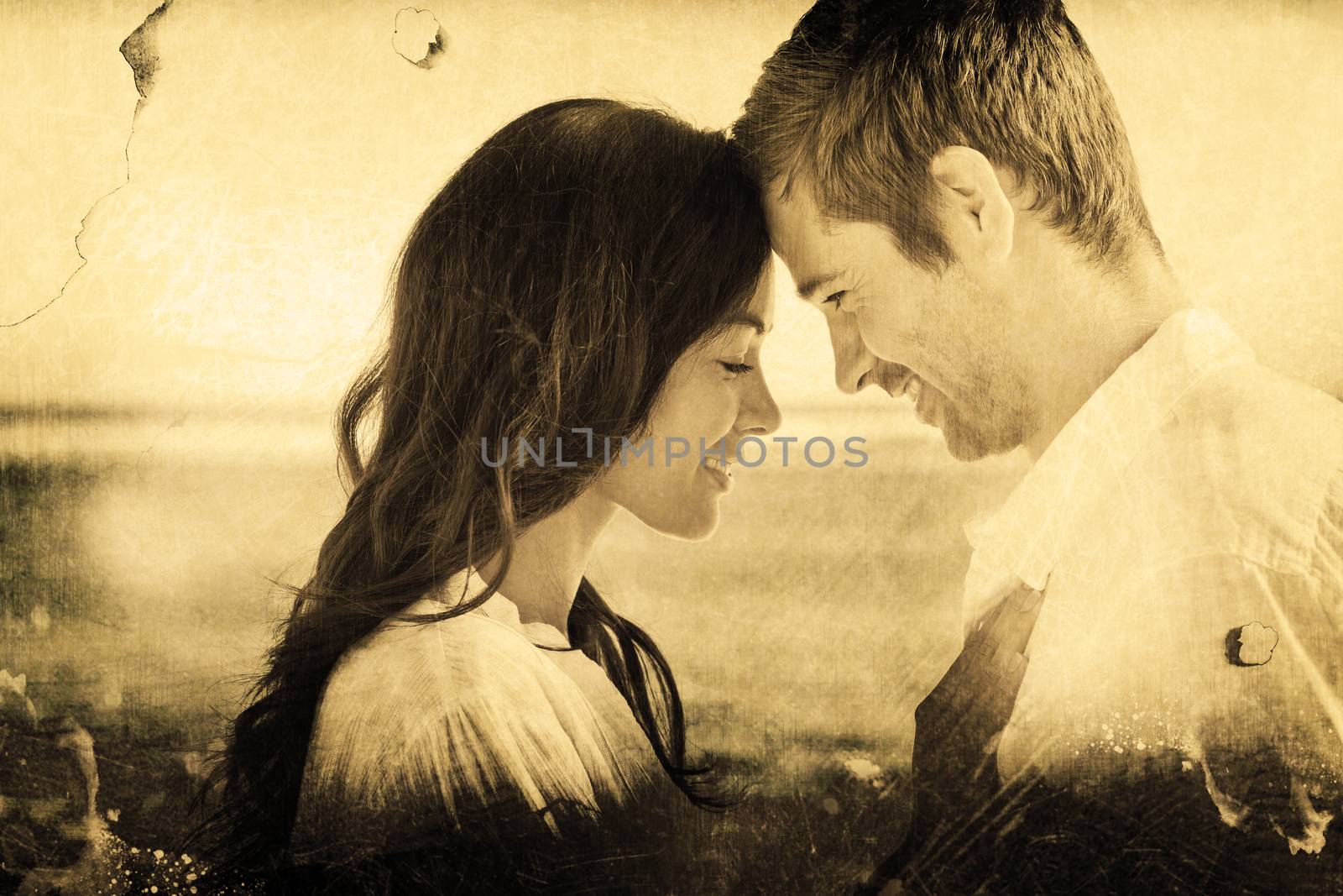 Composite image of romantic couple relaxing and embracing on the beach  by Wavebreakmedia