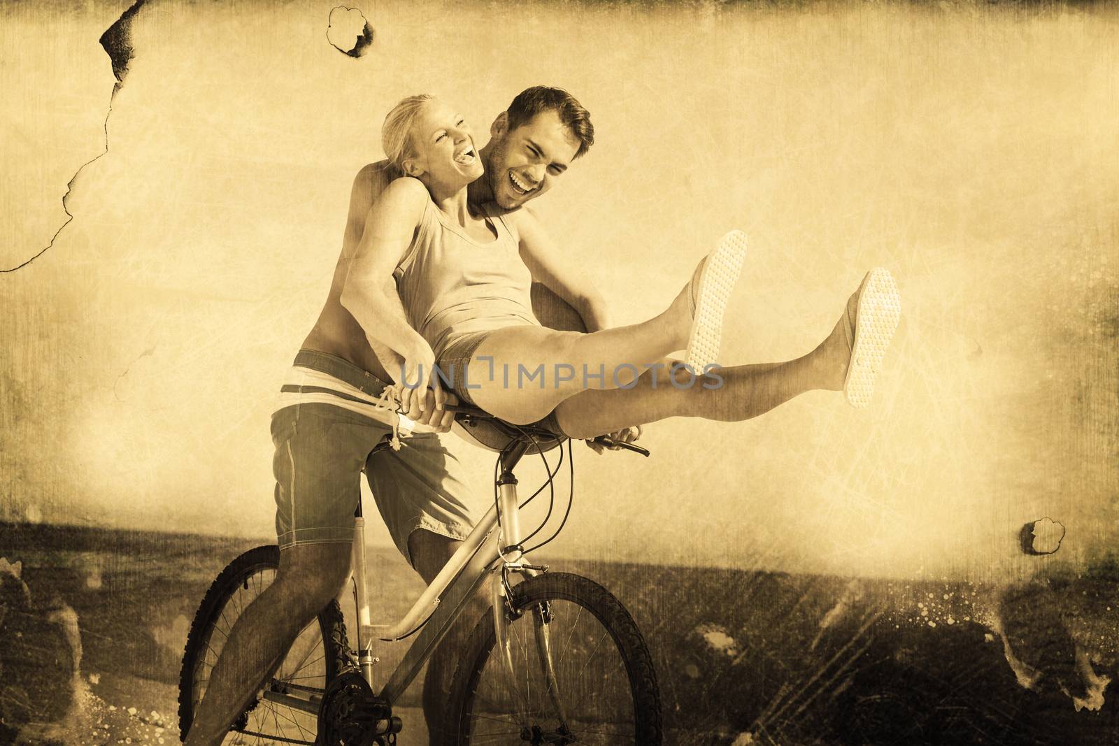 Happy man giving girlfriend a lift on his crossbar against grey background