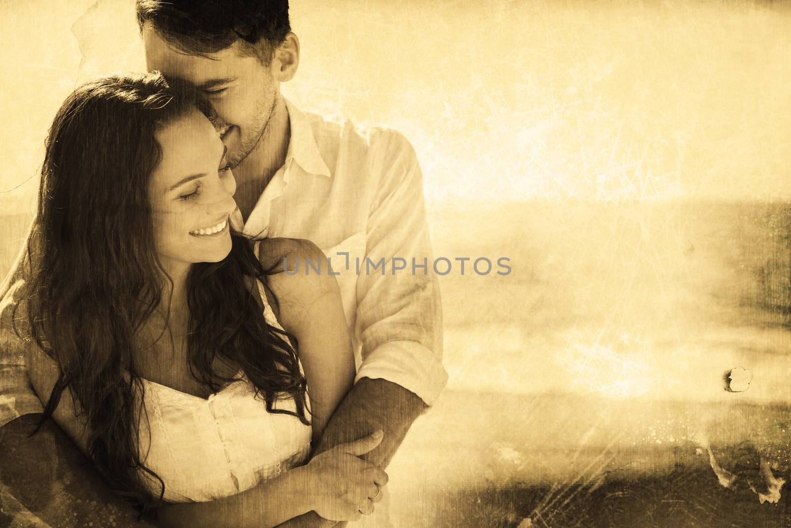 Composite image of attractive couple cuddling by Wavebreakmedia