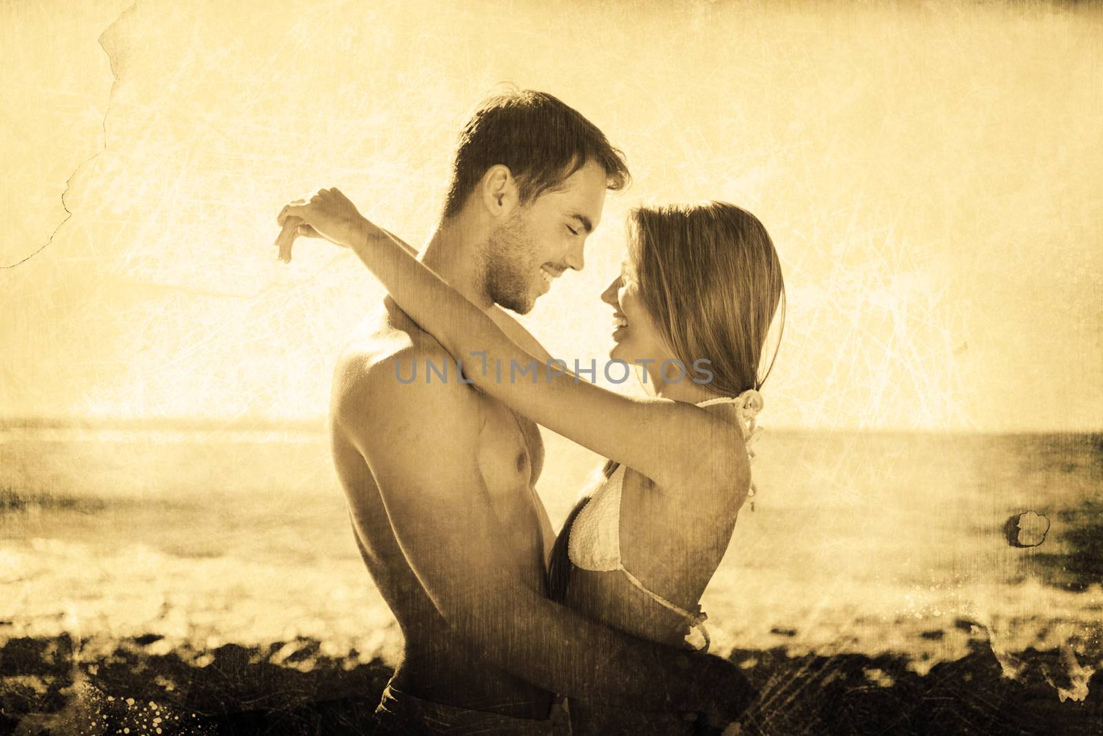 Sexy couple embracing against grey background