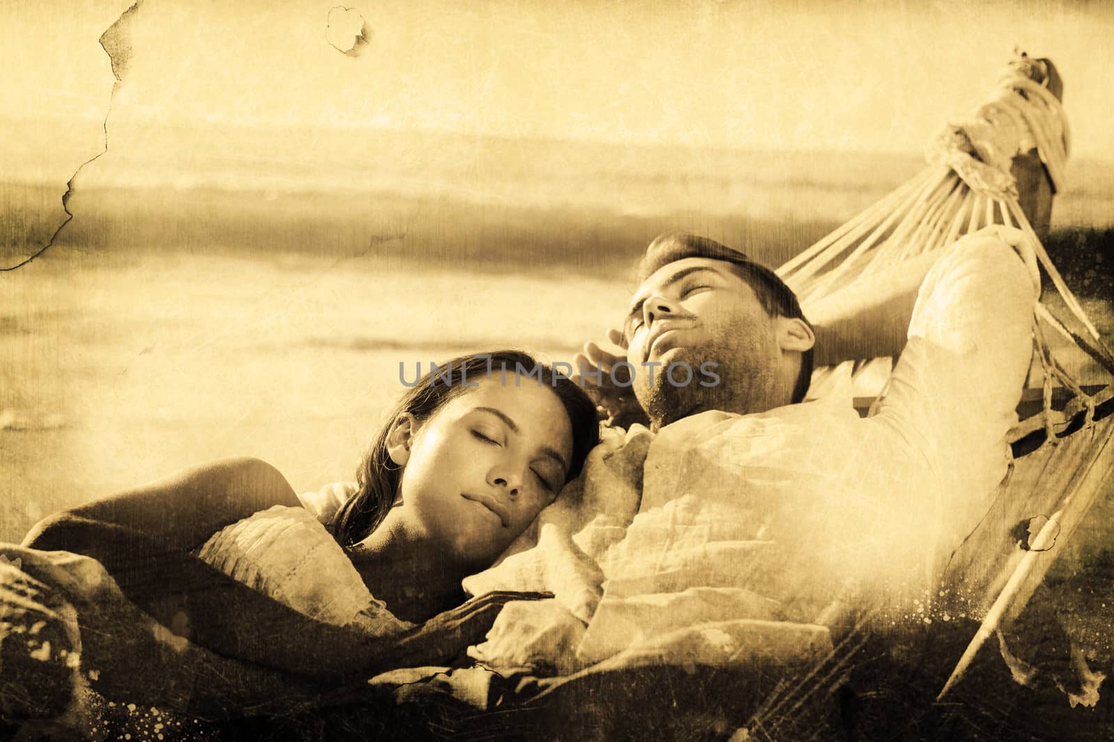 Peaceful couple napping in a hammock against grey background