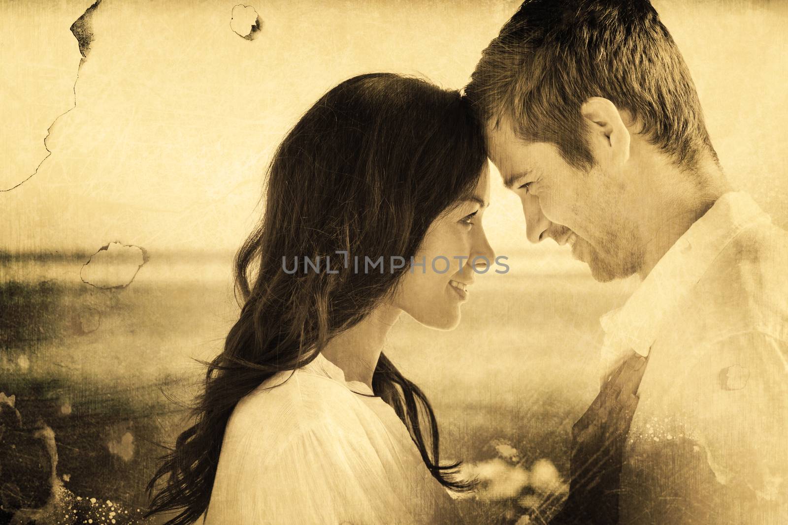 Attractive couple embracing on the beach  against grey background