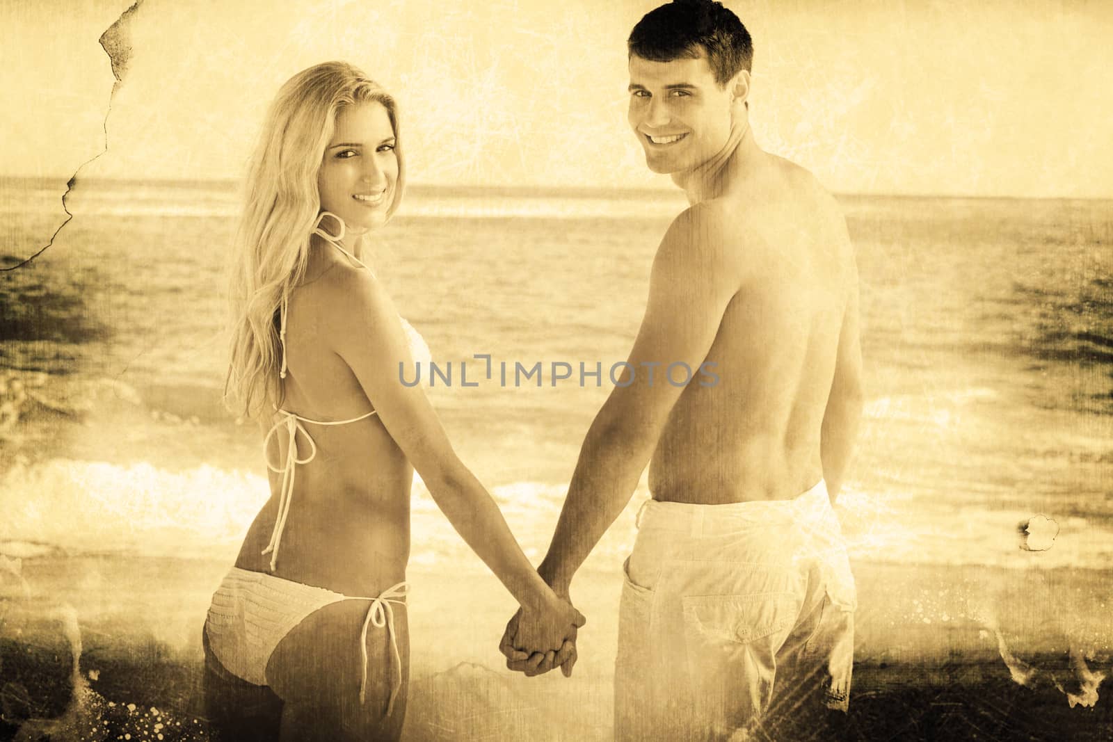 Rear view of couple holding hands looking  against grey background