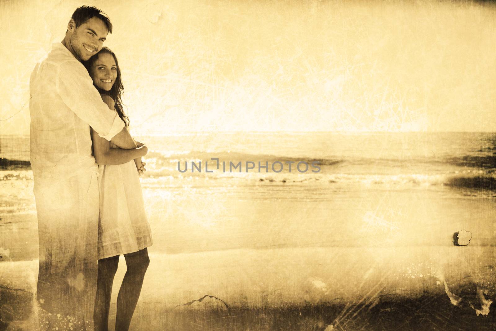 Attractive couple hugging and looking at camera against grey background