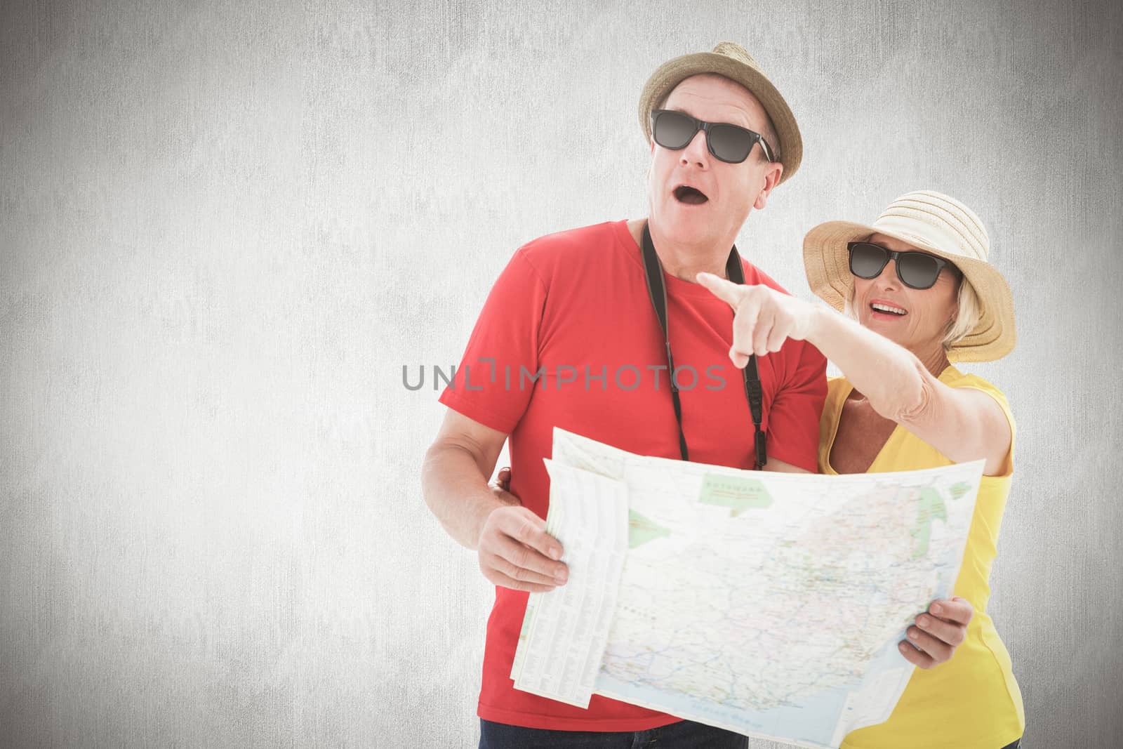 Composite image of happy tourist couple using map by Wavebreakmedia