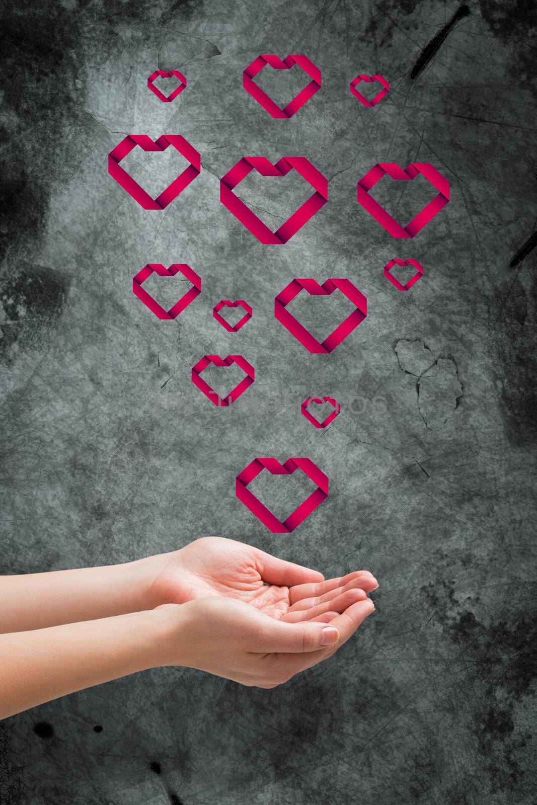 Hands presenting against heart