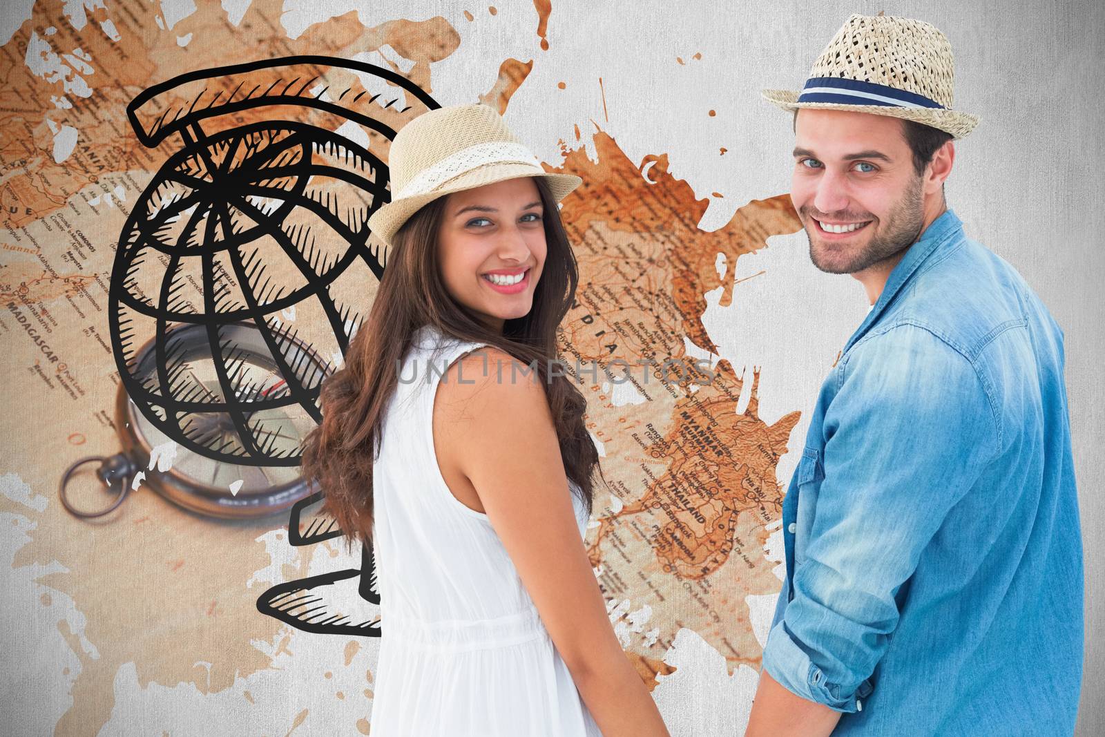 Happy hipster couple holding hands and smiling at camera against world map with compass showing southern asia