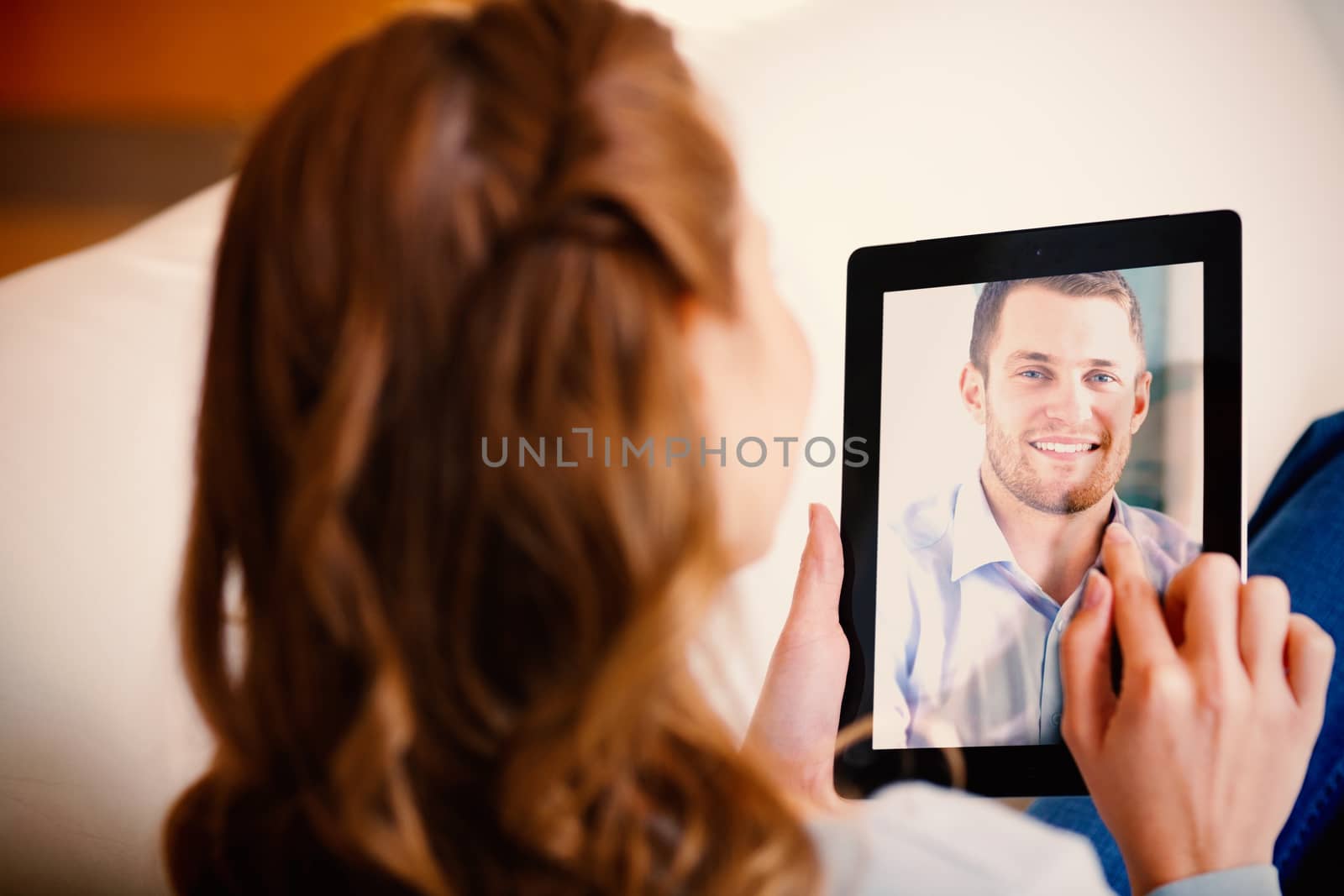 Composite image of businessman with rolled up sleeves on his laptop in his homeoffice