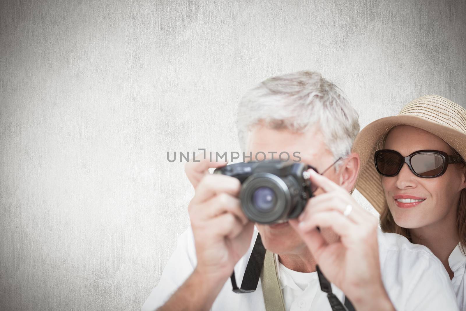 Composite image of vacationing couple taking photo by Wavebreakmedia