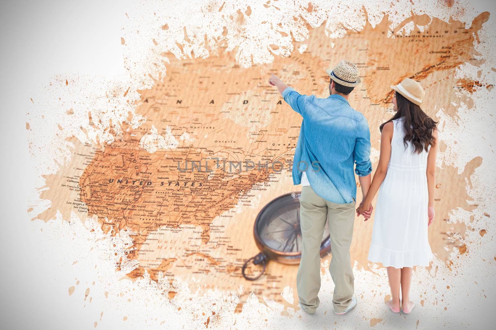 Happy hipster couple holding hands and looking against world map with compass showing north america