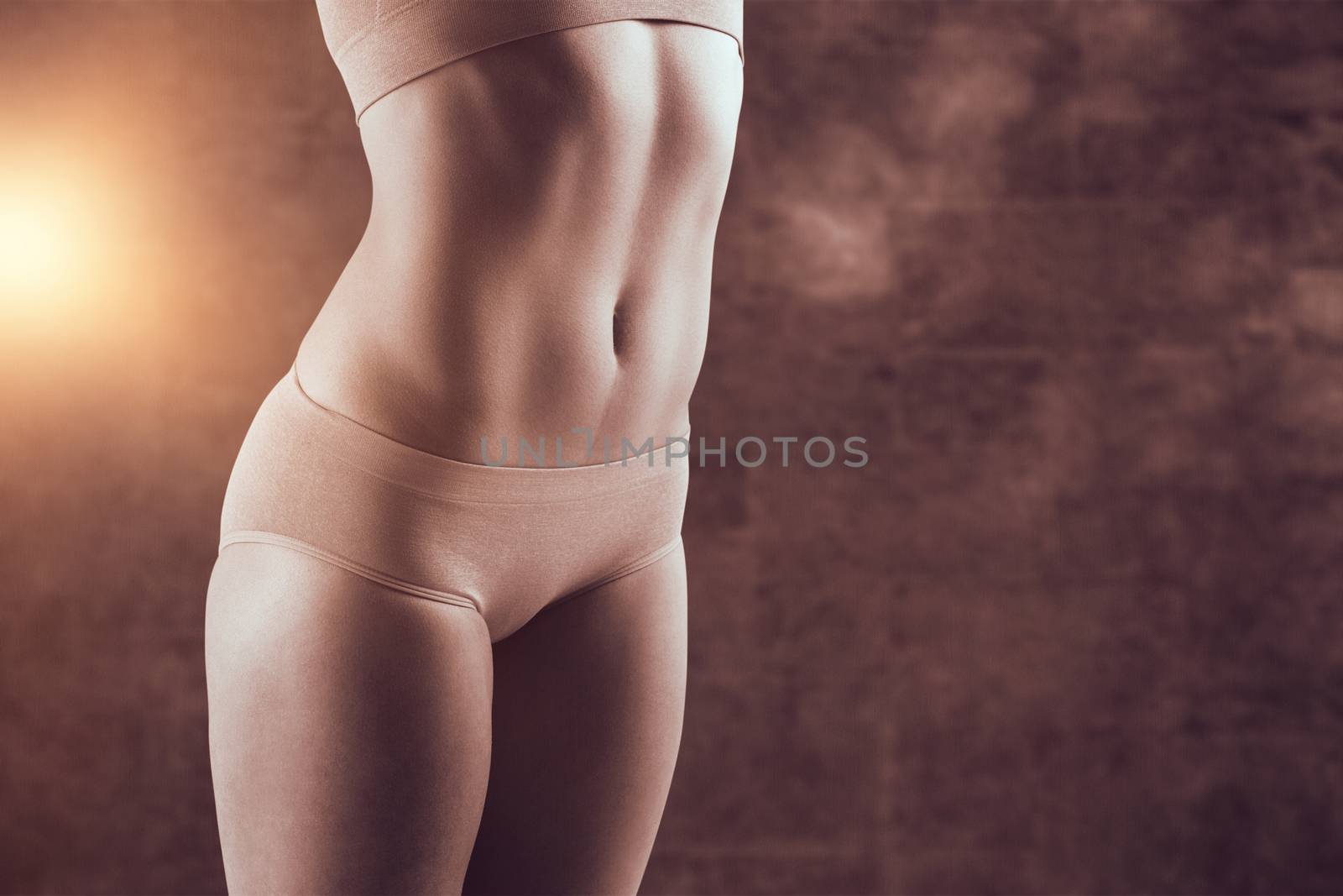Composite image of fit girl stretching in pink bikini by Wavebreakmedia