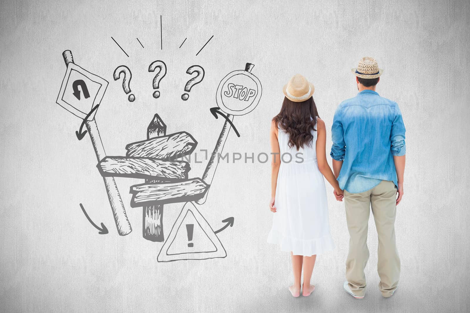 Happy hipster couple holding hands against white background