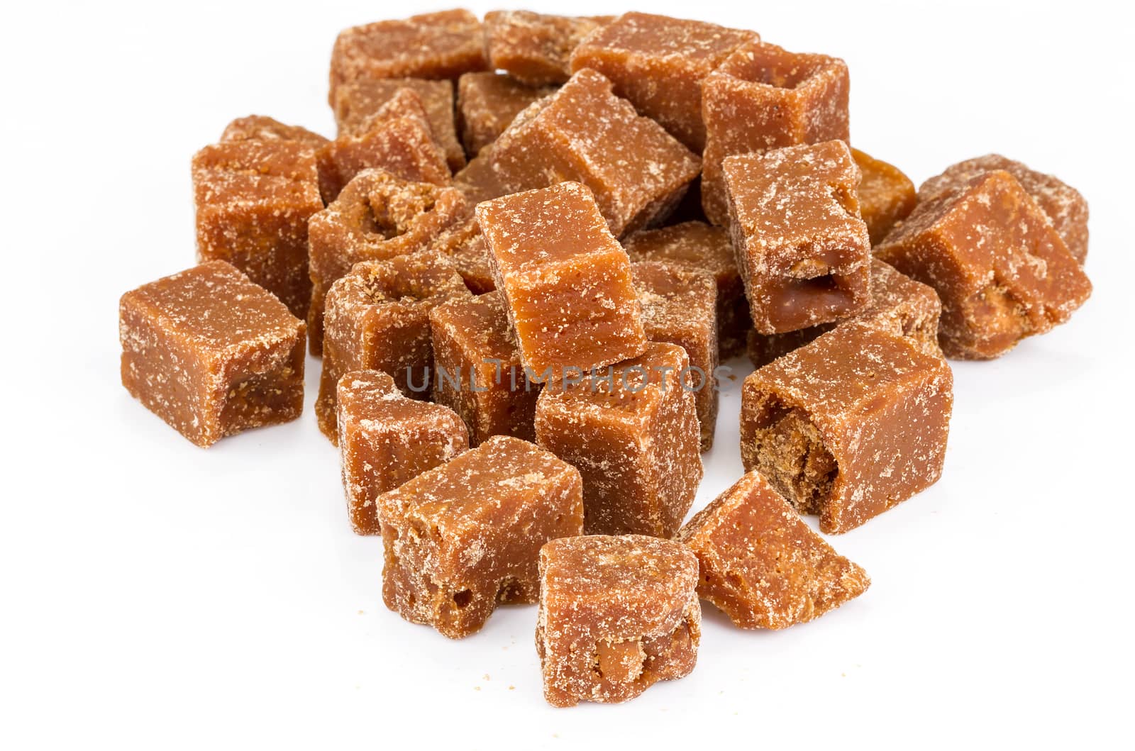 unclarified organic brown cane sugar cube on white background