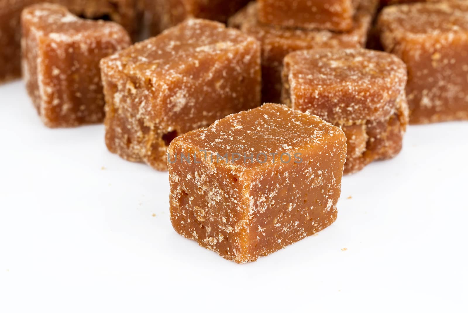 unclarified organic brown cane sugar cube on white background