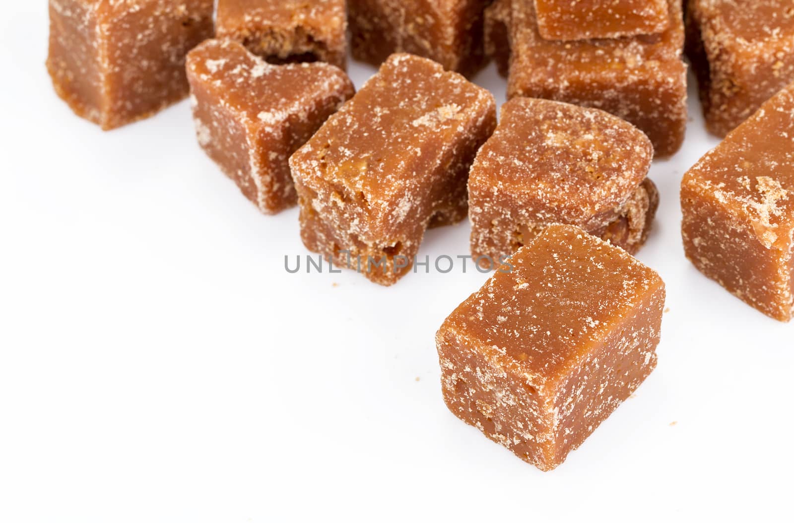unclarified organic brown cane sugar cube on white background