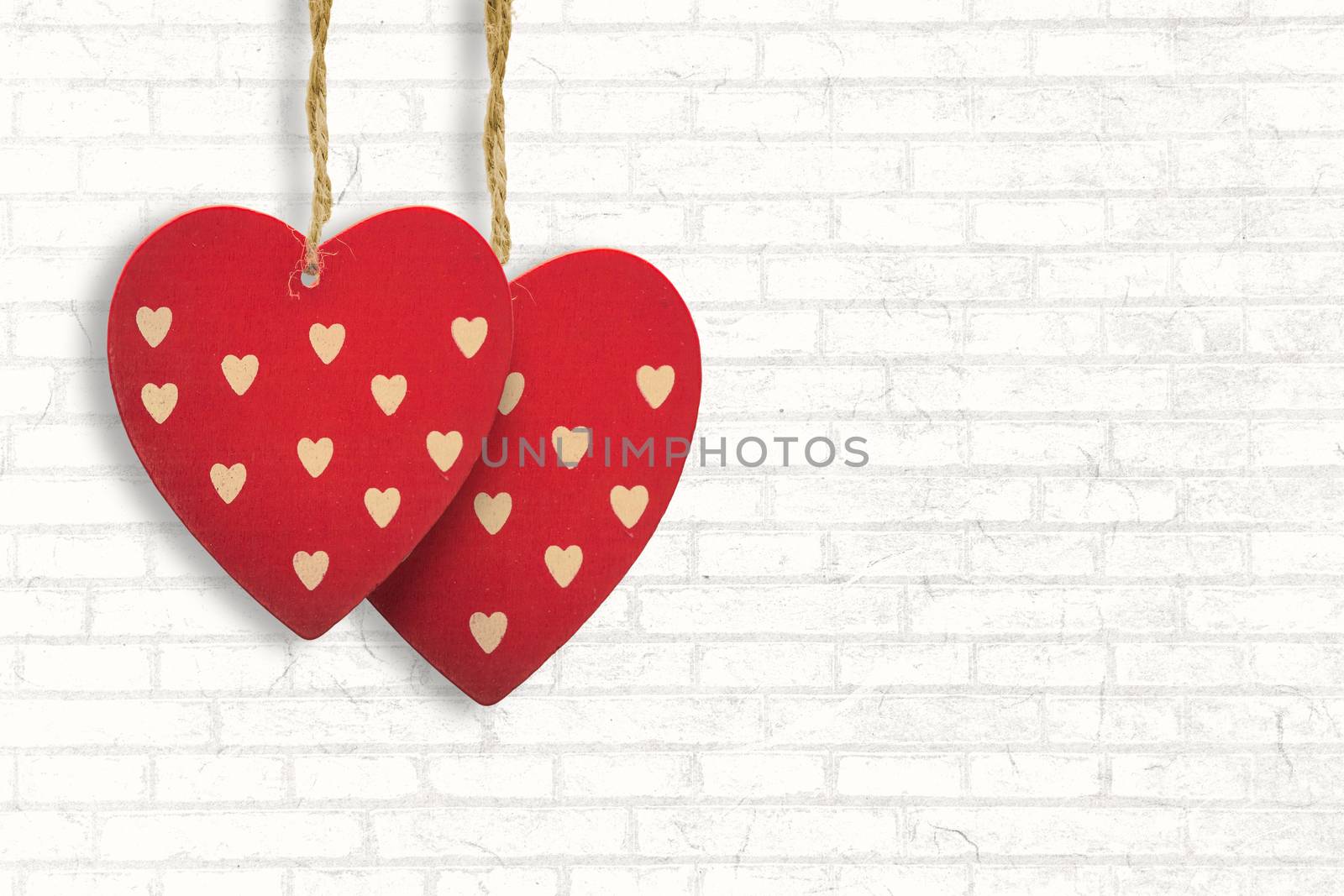 Cute heart decorations against white wall