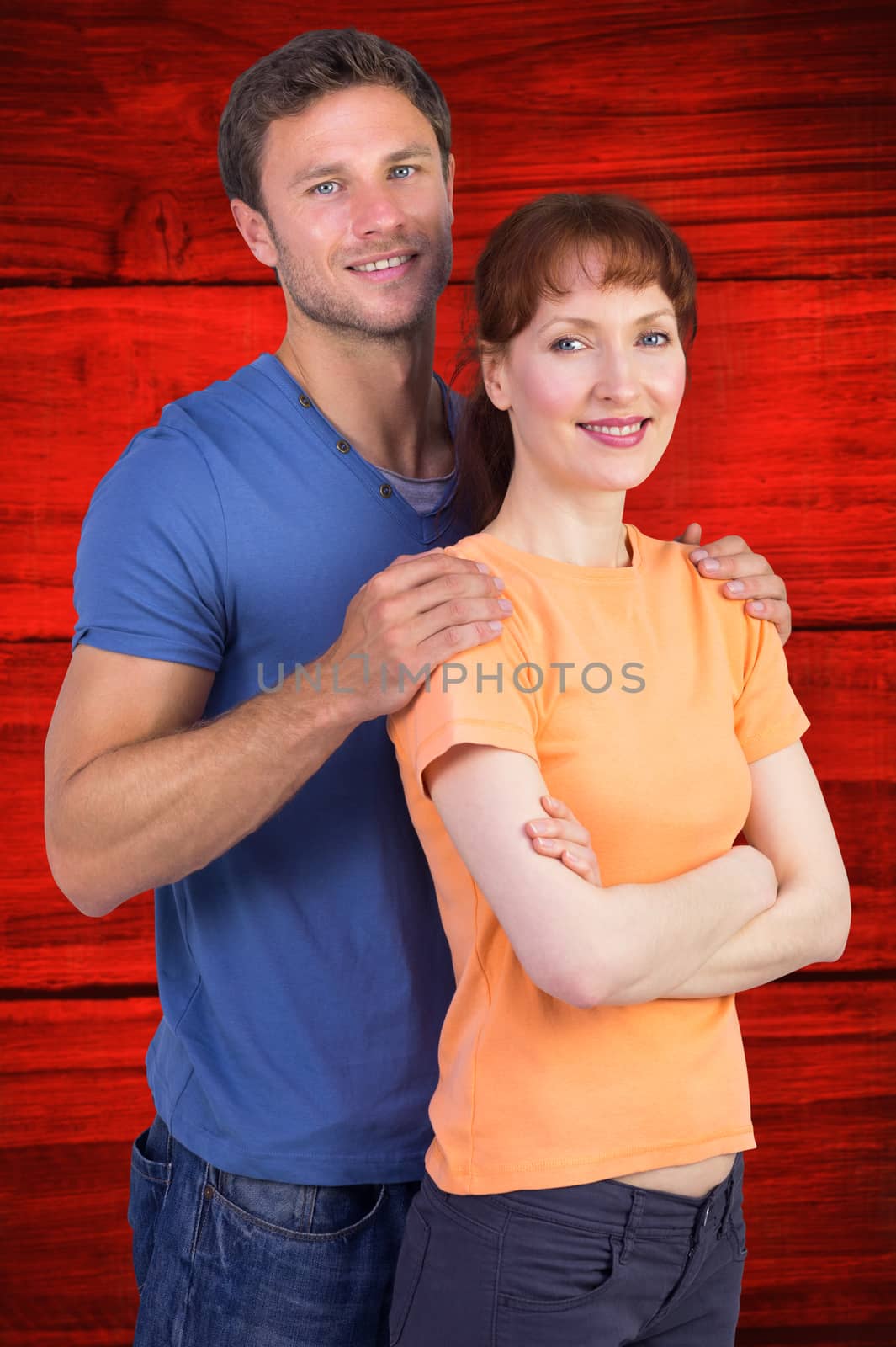 Composite image of happy couple looking at camera by Wavebreakmedia