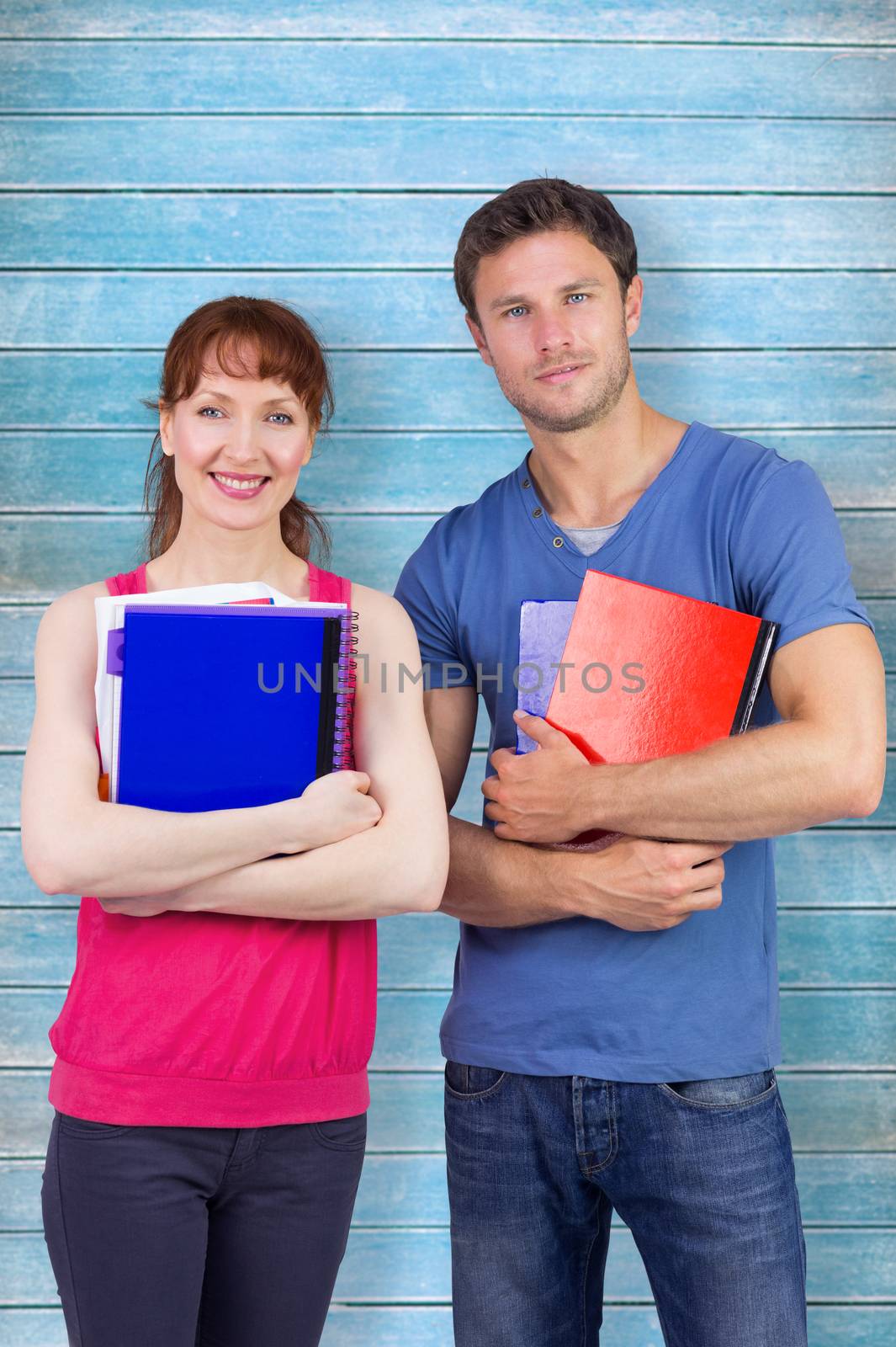 Two students both with notepads against wooden planks