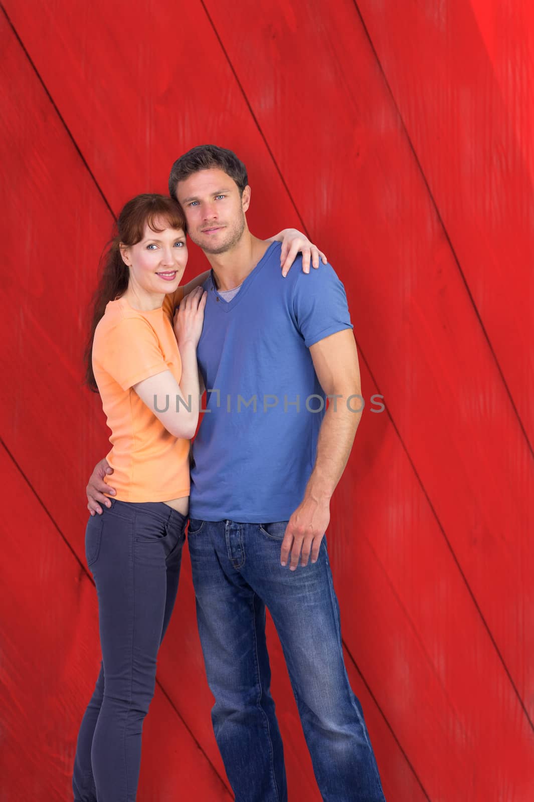 Couple looking at the camera against red wooden planks