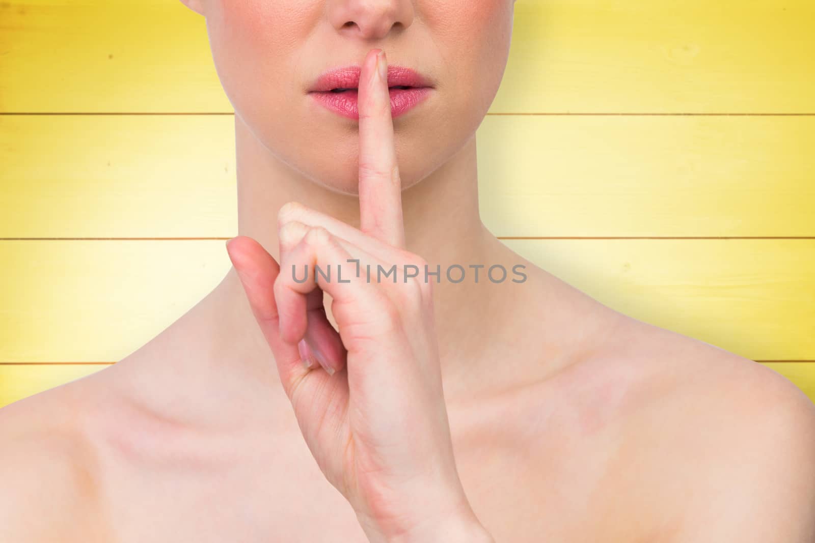 Beautiful woman making quiet gesture against wooden planks