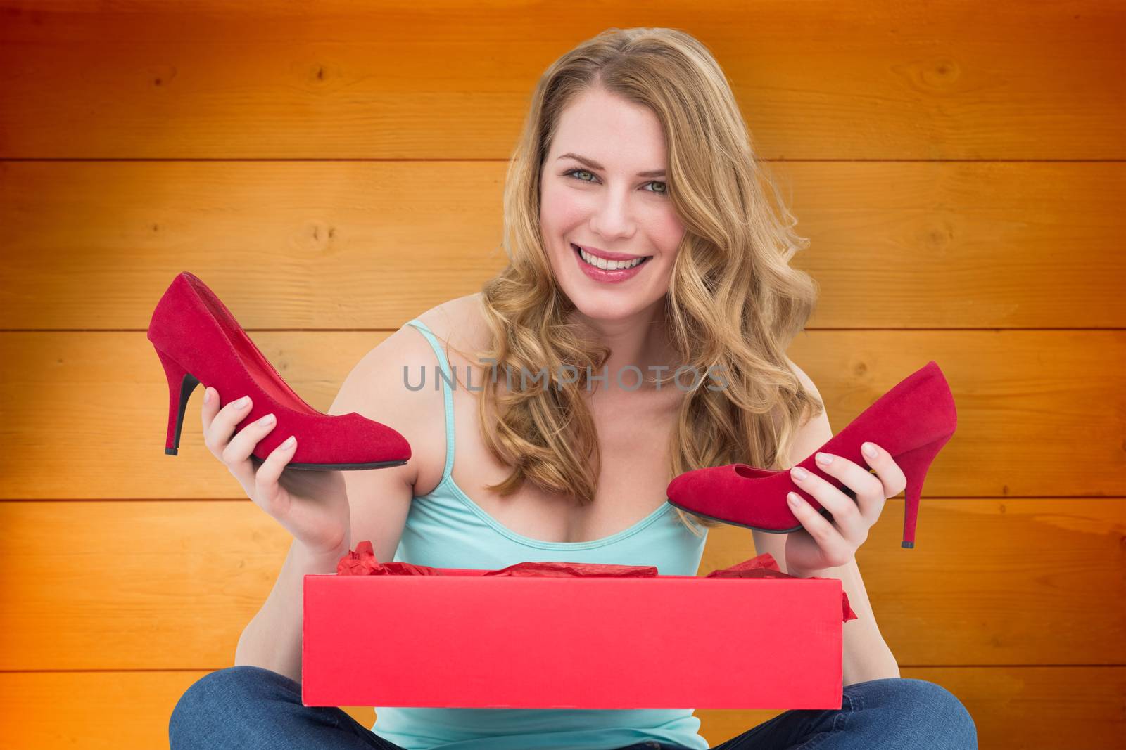 Composite image of woman holding pair of shoes discovered into the box by Wavebreakmedia