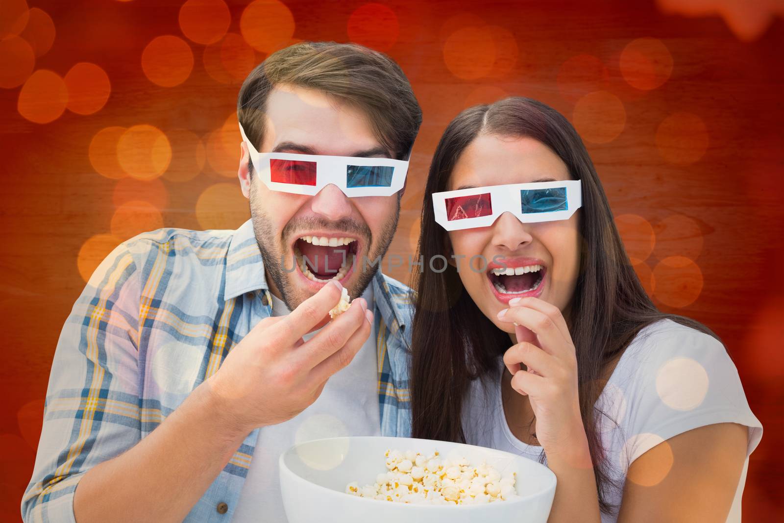 Attractive young couple watching a 3d movie against close up of christmas lights