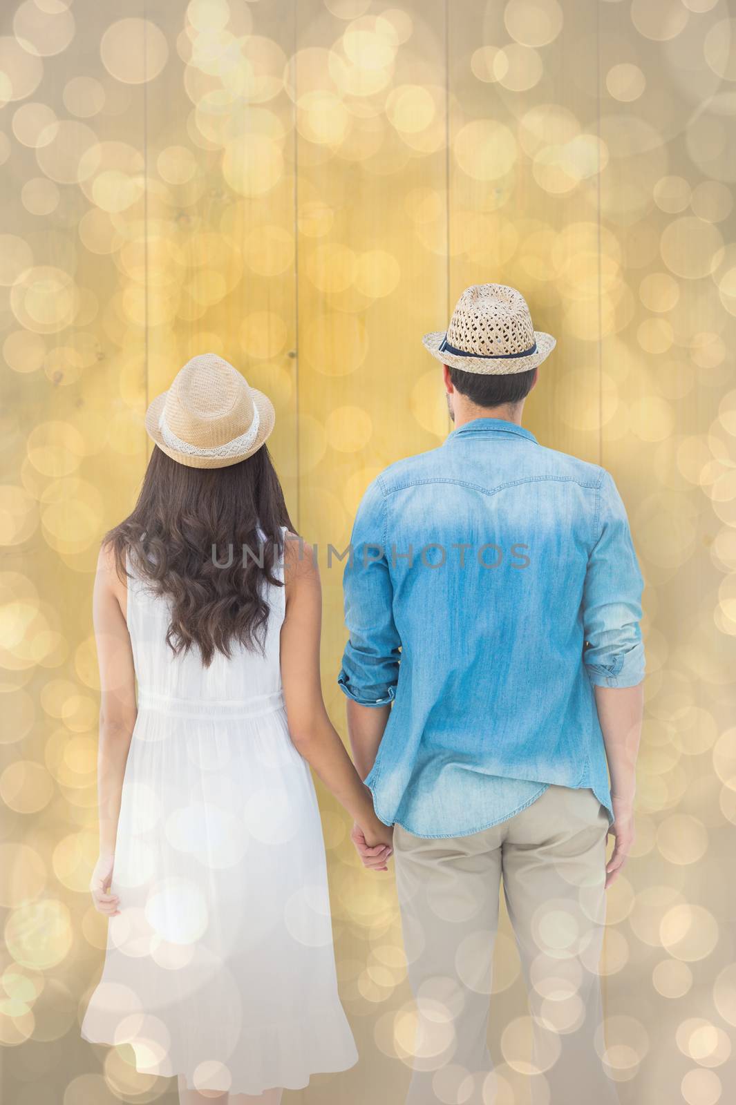 Composite image of happy hipster couple holding hands by Wavebreakmedia