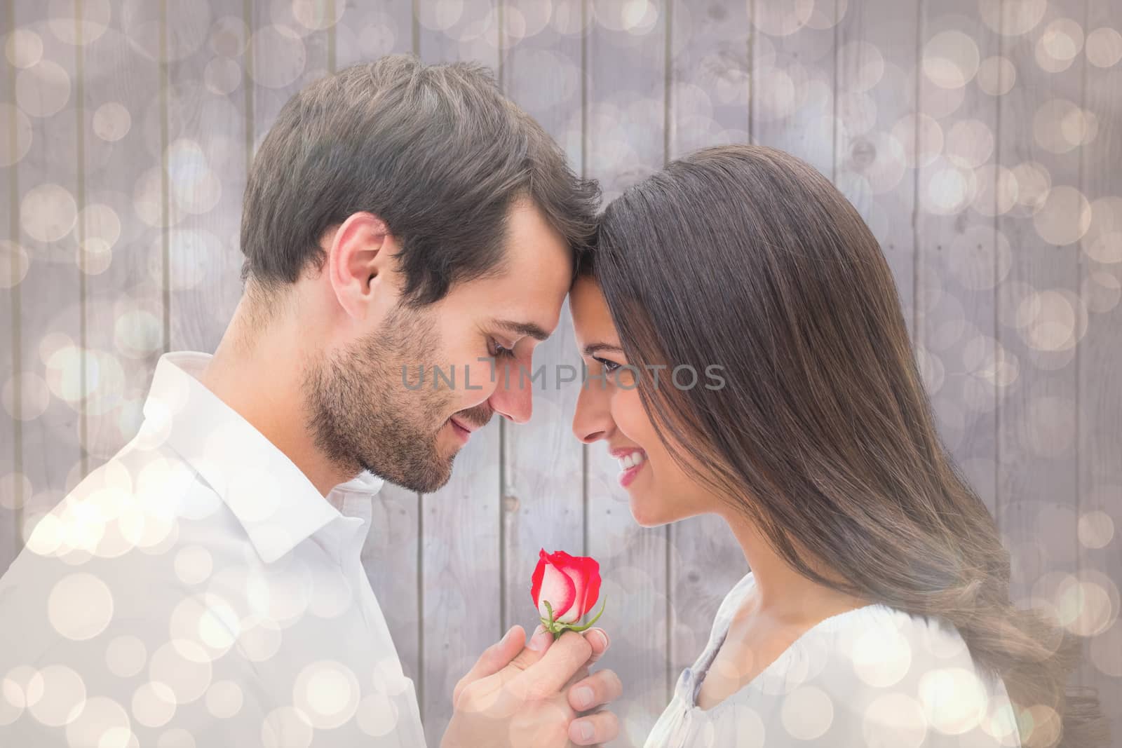 Composite image of handsome man offering his girlfriend a rose by Wavebreakmedia