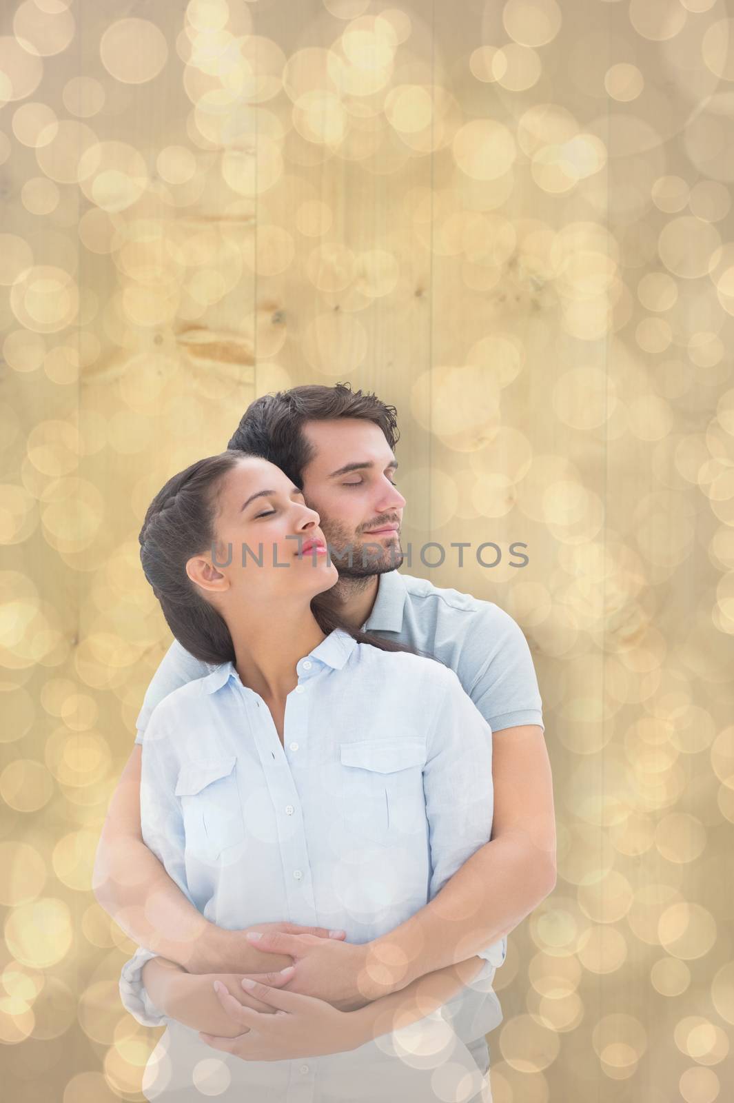 Composite image of cute couple embracing with eyes closed by Wavebreakmedia