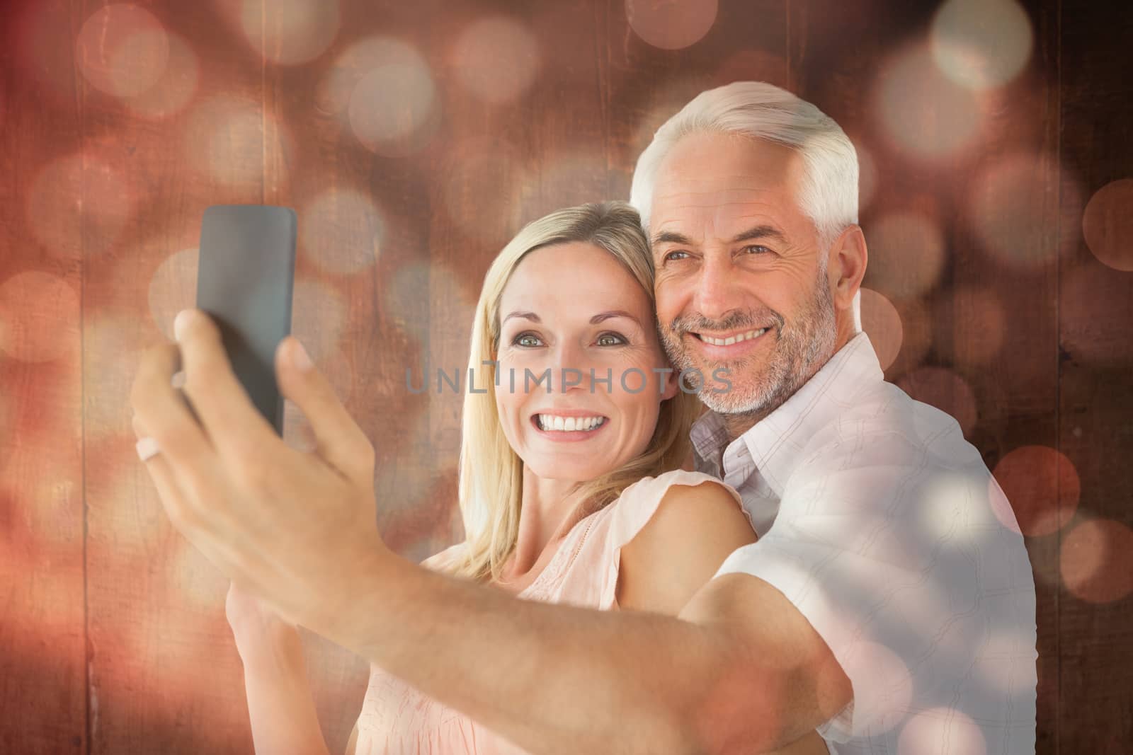 Composite image of happy couple posing for a selfie by Wavebreakmedia