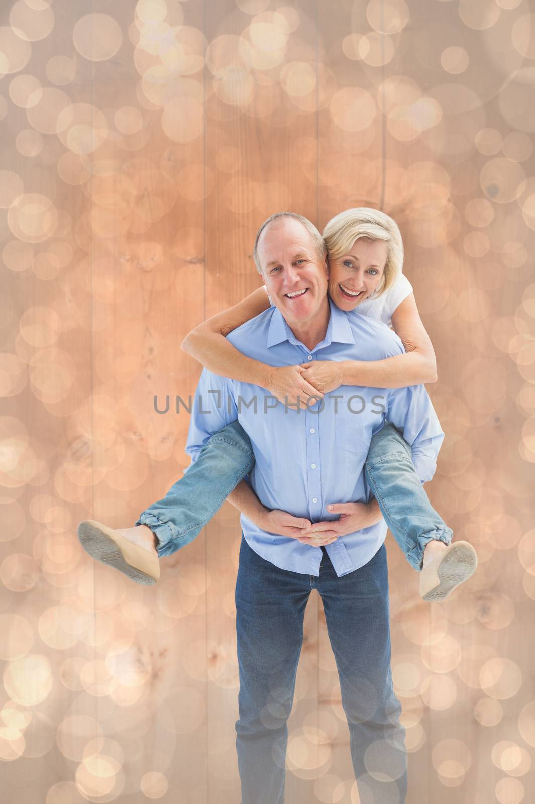 Mature man carrying his partner on his back against light glowing dots design pattern