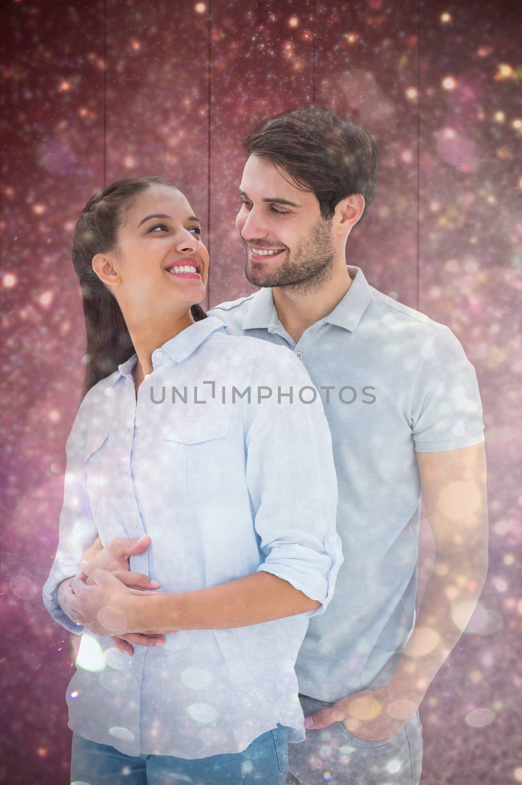 Cute couple embracing and smiling at each other against white snow and stars on black