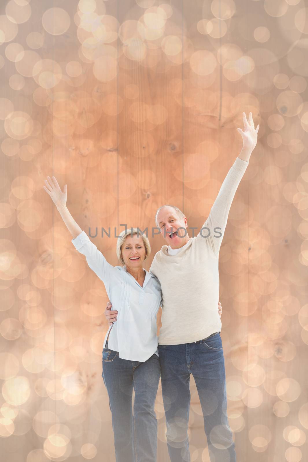 Happy mature couple cheering at camera against light glowing dots design pattern