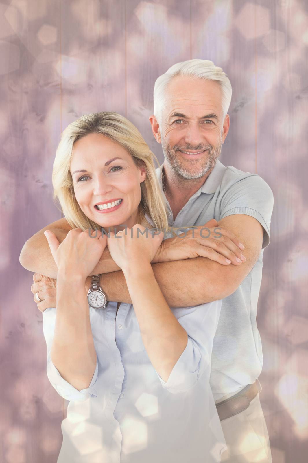 Happy couple standing and hugging against light glowing dots design pattern