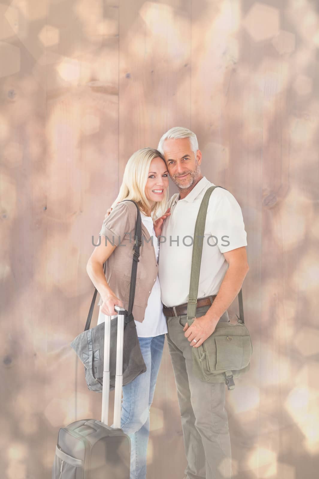 Happy couple ready to go on holiday against light glowing dots design pattern