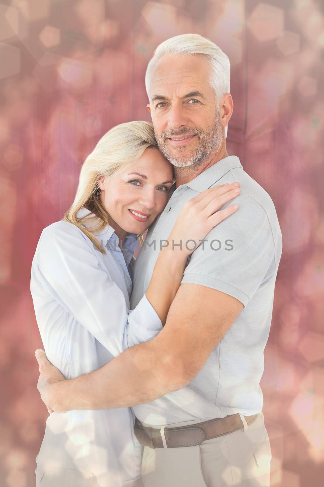 Happy couple standing and smiling at camera against light glowing dots design pattern