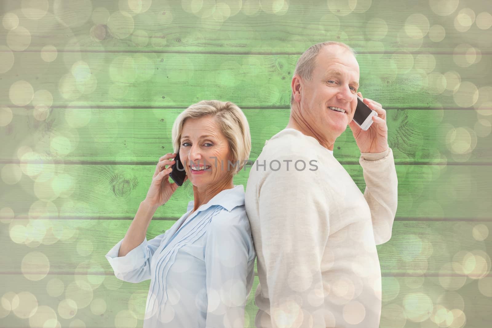 Composite image of happy mature couple talking on their phones by Wavebreakmedia