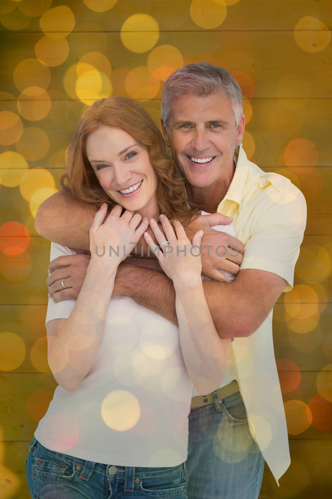 Composite image of casual couple smiling and hugging by Wavebreakmedia