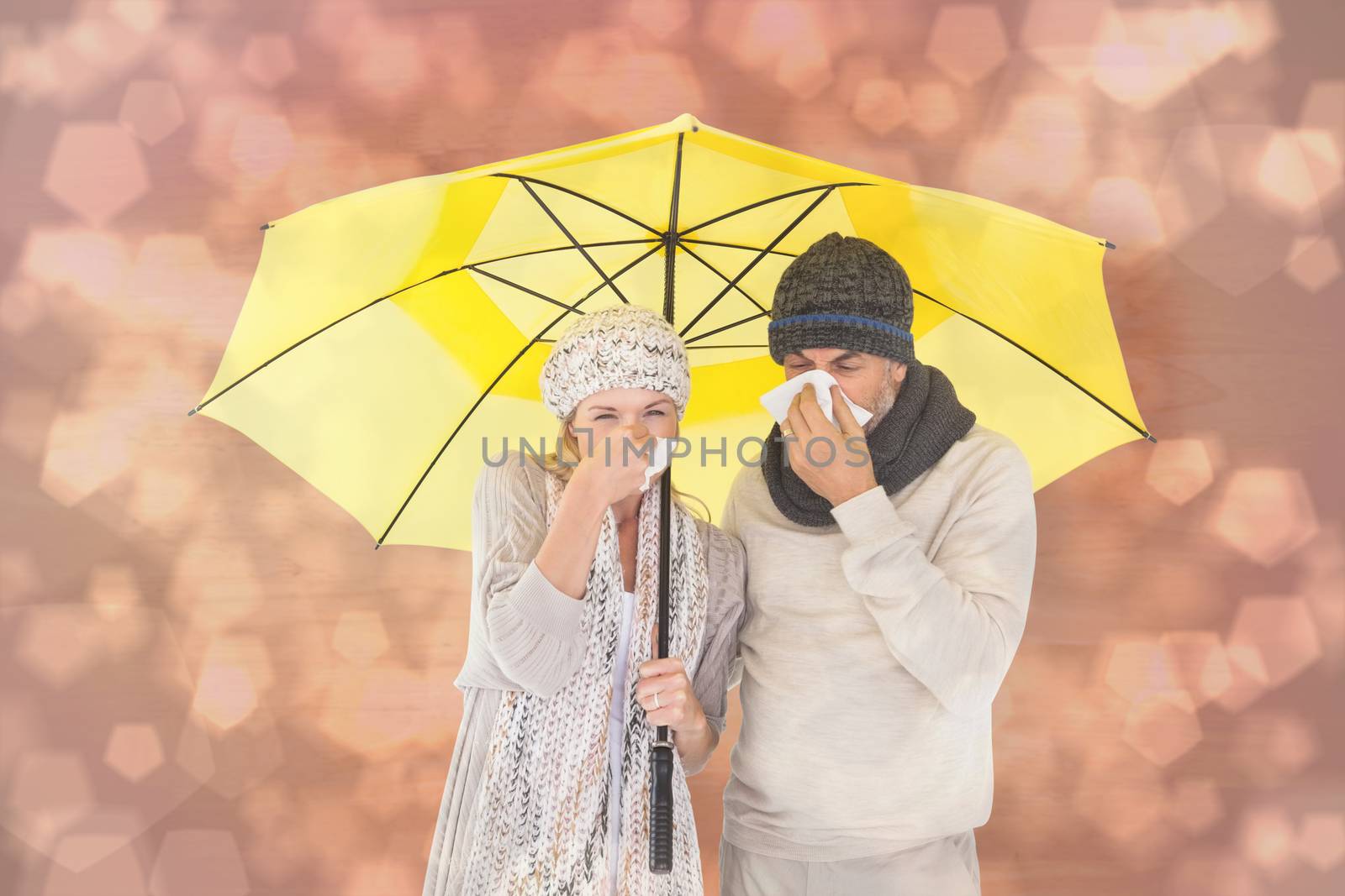 Couple in winter fashion sneezing under umbrella against light glowing dots design pattern